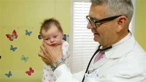 How To Calm A Crying Baby - Dr. Robert Hamilton Demonstrates "The Hold ...