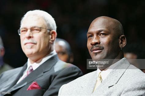 Phil Jackson and Michael Jordan watch the ceremony retiring the ...