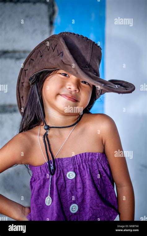 A cute young Filipino girl models her purple dress and brown leather ...