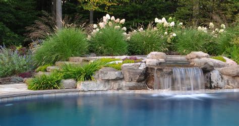 A beautiful swimming pool waterfall comes from the upper level spa ...