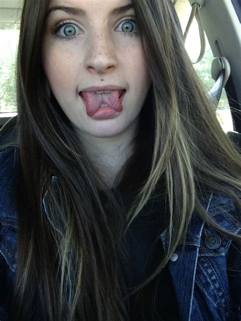 a woman sticking her tongue out in the back seat of a car, making a funny face