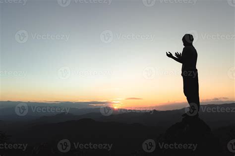 Man praying at sunset mountains, concept vacations outdoor harmony with ...