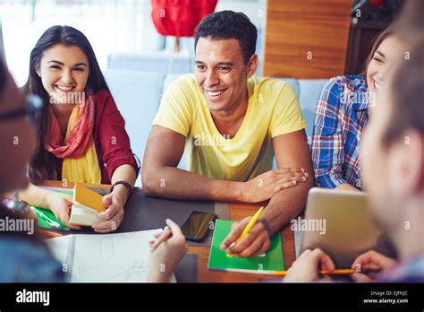 Smiling students having conversation with their friends Stock Photo - Alamy