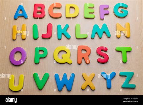 Colorful letters on wooden background, alphabetical order, top view ...