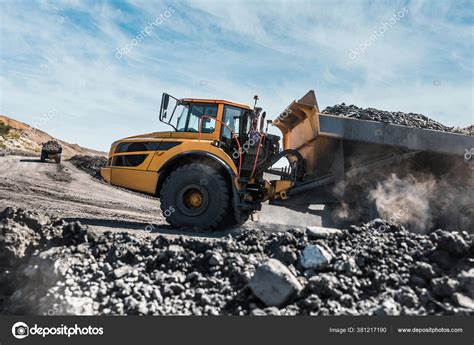 Large quarry dump truck. Loading the rock in dumper. Loading coal into ...