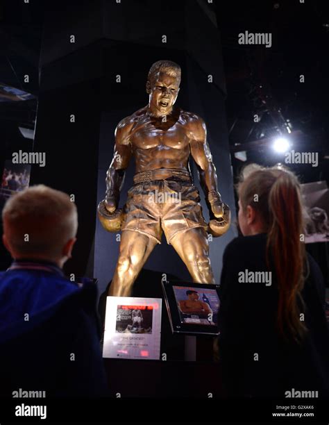 Visitors look at a statue of Muhammad Ali on display at the Muhammad ...