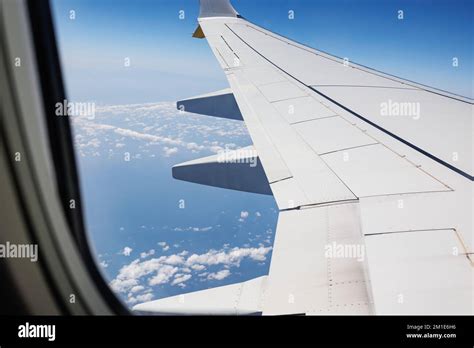 View from Inside an Aircraft: Window of the Cabin, White Airplane Wing ...