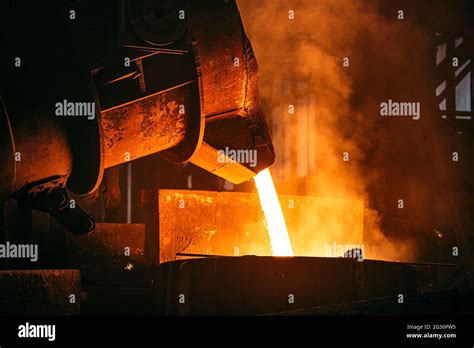 Foundry. Metal Cast Process. Molten Iron pouring with sparks and smoke ...