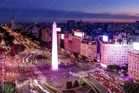 Aerial view of Buenos Aires and 9 de julio avenue at night with purple ...