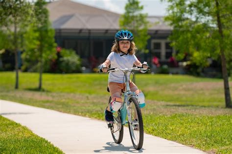 Premium Photo | Kid riding bike in a helmet child with a childs bike ...