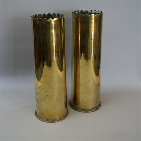 A pair of 1917 brass artillery shells with trench art with punched decoration