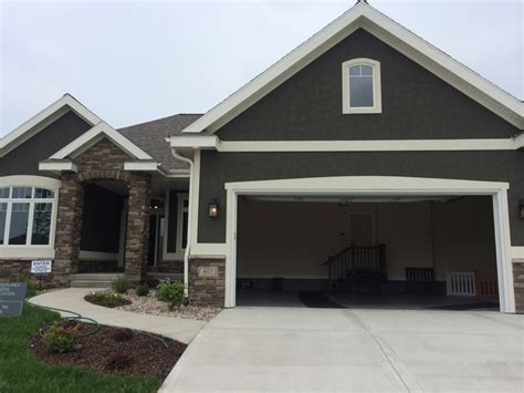 dark grey stucco exterior, white trim, nice stone entrance MABA Parade ...