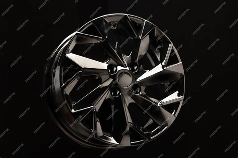 Premium Photo | Black alloy wheel on black background