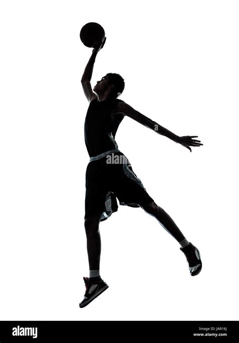 one young man basketball player dunking silhouette in studio isolated on white background Stock ...