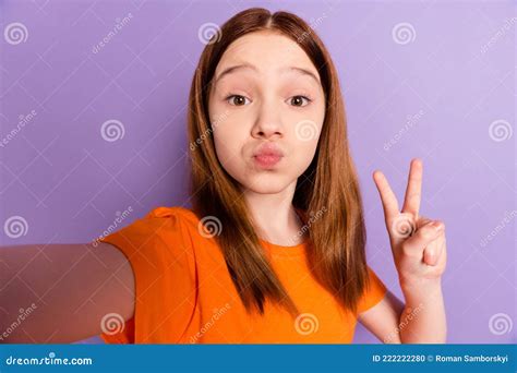 Self-portrait of Attractive Funny Girl Blowing Lips Showing V-sign Having Fun Isolated Over ...