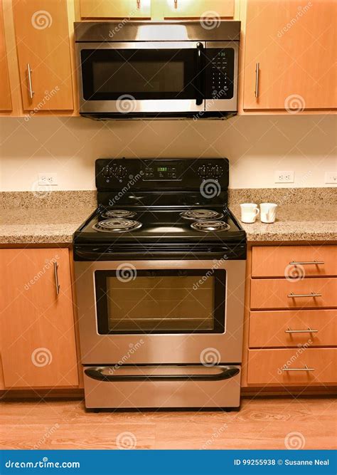 Range, Stove, and Microwave and Kitchen Cabinets Stock Photo - Image of matching, flooring: 99255938