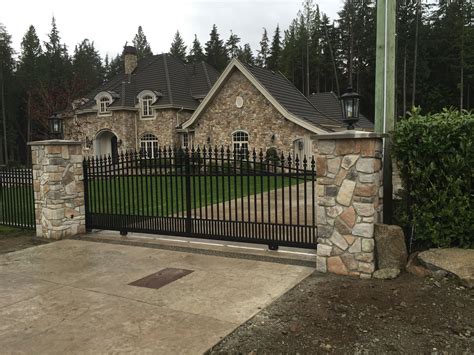 Stone pillars with sliding gate and lights | House gate design, Stone ...