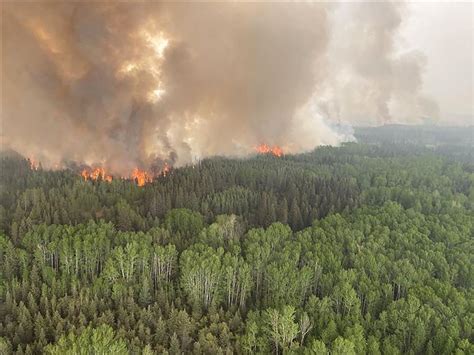 Canadian PM Trudeau visits Alberta as wildfires rage | Reuters