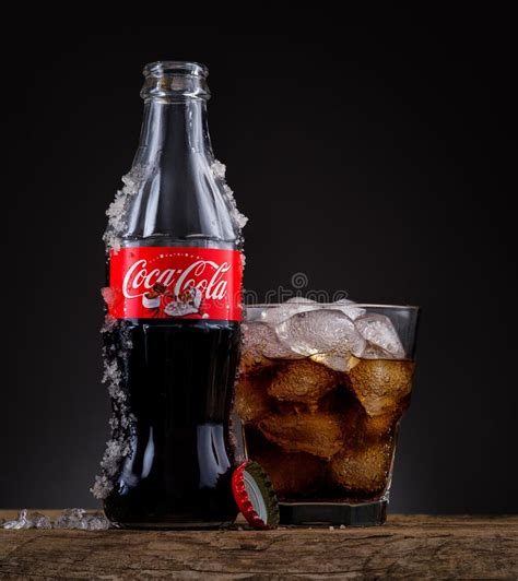 Can, Bottle and Glass of Coca-Cola with Ice on Wooden Background Editorial Stock Image - Image ...