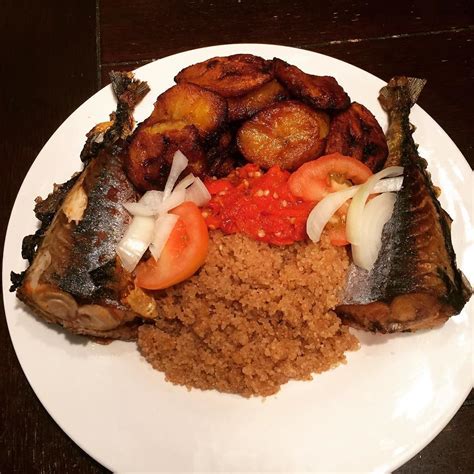 a white plate topped with fried fish and rice