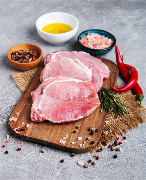 Fresh raw pork chops with spices ~ Food & Drink Photos ~ Creative Market