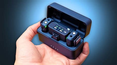a hand is holding an electronic device in its case with buttons and ...
