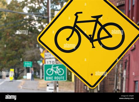 Yellow and green bike route road signs Stock Photo - Alamy