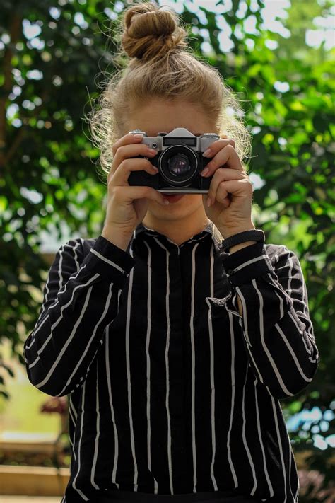 Portrait Photo of Woman in Black and White Striped Top Taking Photo · Free Stock Photo