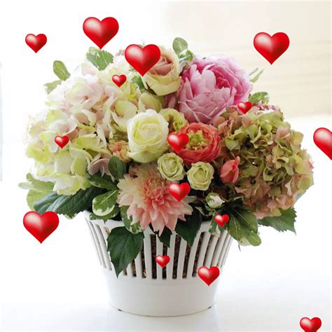 a vase filled with lots of flowers and hearts