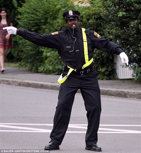 Shaquille O'Neal wears a comical wig as he dons a police uniform for his new film Grown Ups 2 ...