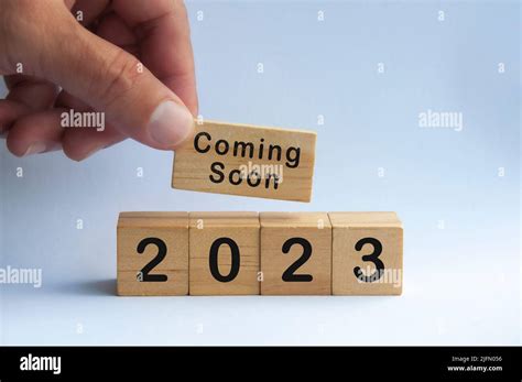 Hand holding wooden block with text - 2023 coming soon. New year concept Stock Photo - Alamy