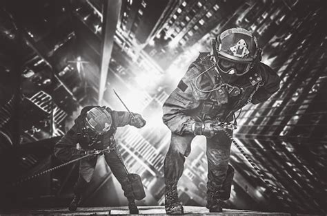 Premium Photo | Two rescuers descend from a skyscraper to rescue people from a fire. the concept ...