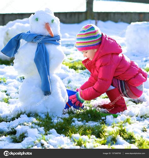 Little child playing outdoors in winter Stock Photo by ©CroMary 137349700