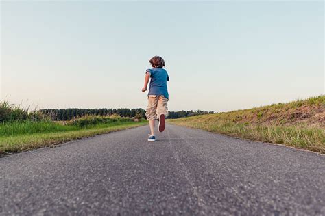 "Boy Running Away On A Long Road In The Fields" by Stocksy Contributor ...