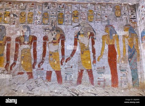 Ancient paintings and Egyptian hieroglyphs at the pharaoh tomb in the Valley of the Kings in ...