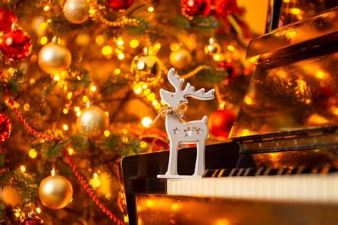 Premium Photo | Wooden deer toy on the piano shiny decorated christmas ...