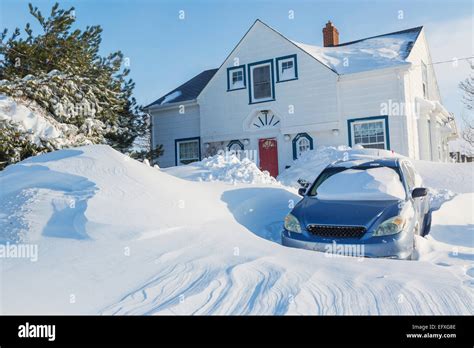 Snow piling up in a city neighborhood Stock Photo - Alamy