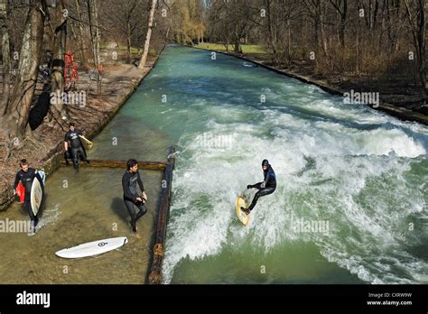 Surfer surfing on Eisbach creek, Englischer Garten park, Munich ...