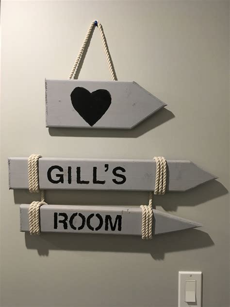 two wooden signs hanging on the wall that say gill's room