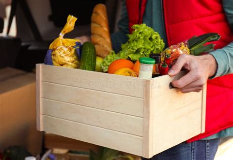 Courier Holding Crate with Products Near Car Outdoors. Food Delivery Service Stock Image - Image ...