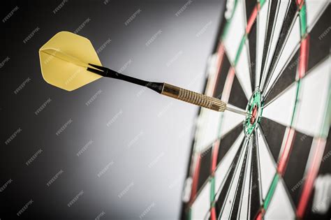 Premium Photo | Closeup of a dart in bullseye