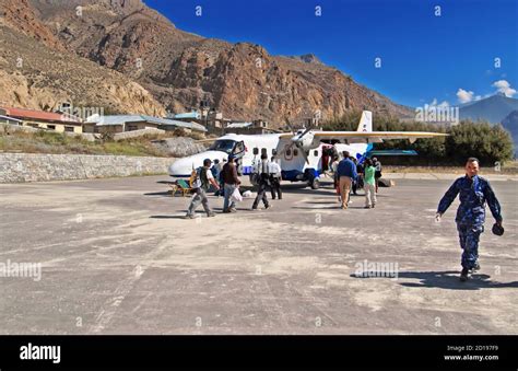 JOMSOM, NEPAL - OCTOBER 05, 2008: Passengers enter to the plane of Sita ...