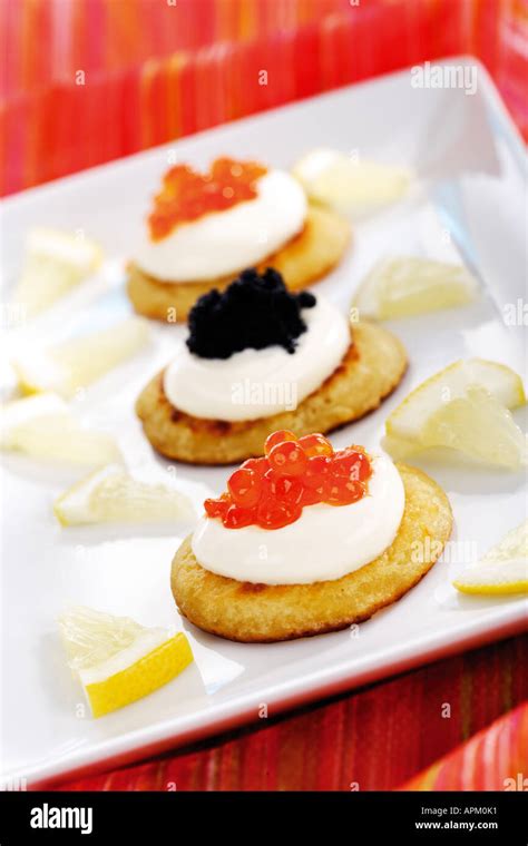 Blini with sour cream snd caviar Stock Photo - Alamy