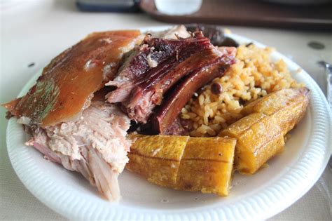 Lechon (roasted pig), plantain, rice and pigeon peas, blood sausage, Guavate, Puerto Rico ...