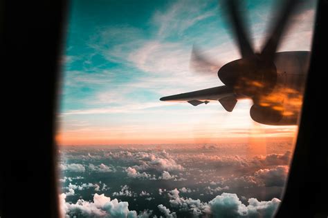 Airplane Flying over Clouds during Sunset · Free Stock Photo