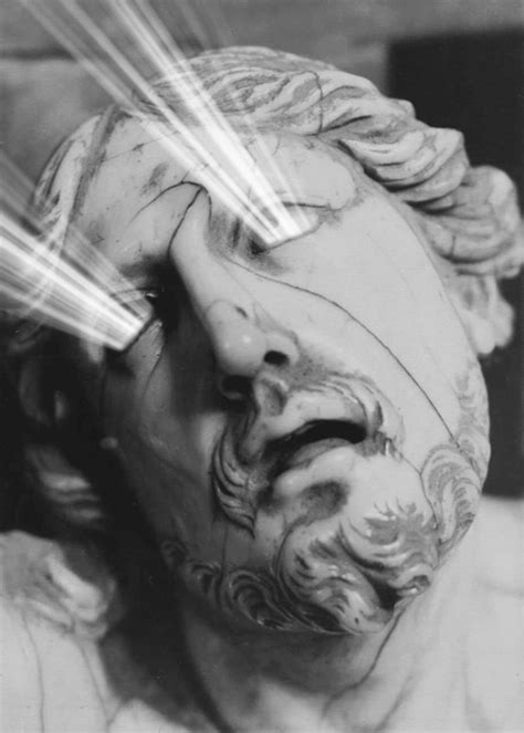 the head of a statue is shown with light coming out of it's eyes