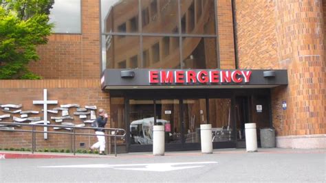 PORTLAND, OREGON - CIRCA 2013: Hospital Entrance With Professional Woman Entering Through Front ...