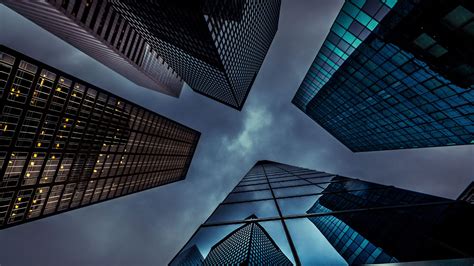 looking up at skyscrapers in the sky from ground level, with lights ...