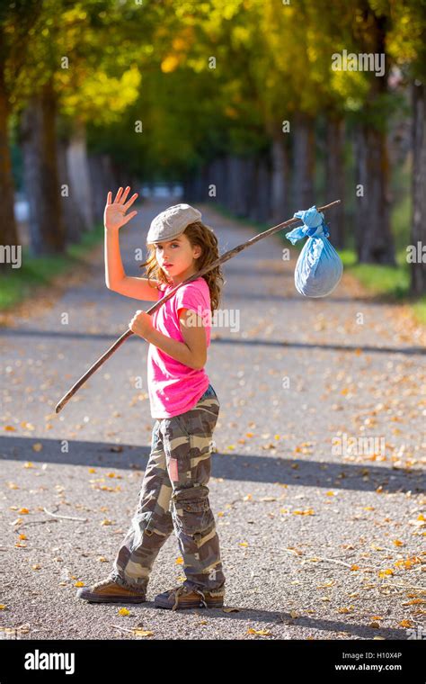 little kid with hobo stick bag and bundle girl saying goodbye Stock Photo - Alamy