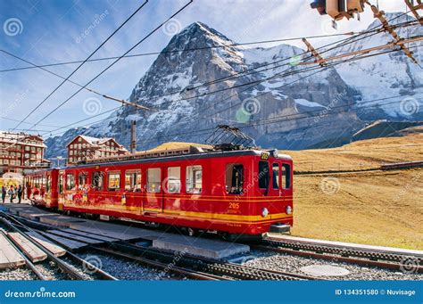 Jungfrau Railway Train at Kleine Scheidegg Station with Eiger and Monch ...